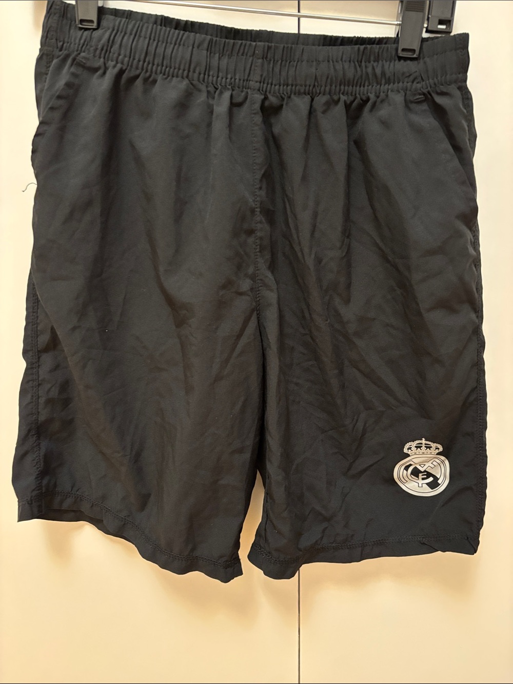 Men's Black Athletic Shorts with Team Crest for Real Madrid soccer team.